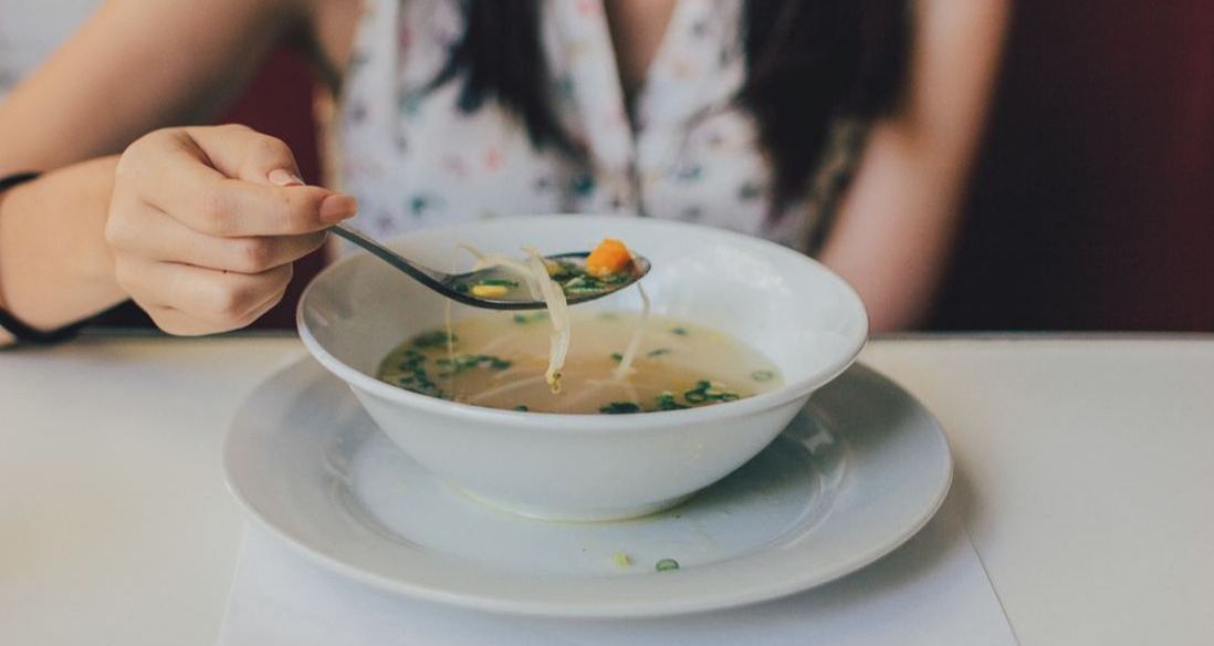 Photo of Girl eating bowl of soup